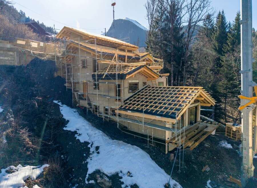 This stunning property under construction showcases a modern architectural design, perfectly blending with its natural surroundings.