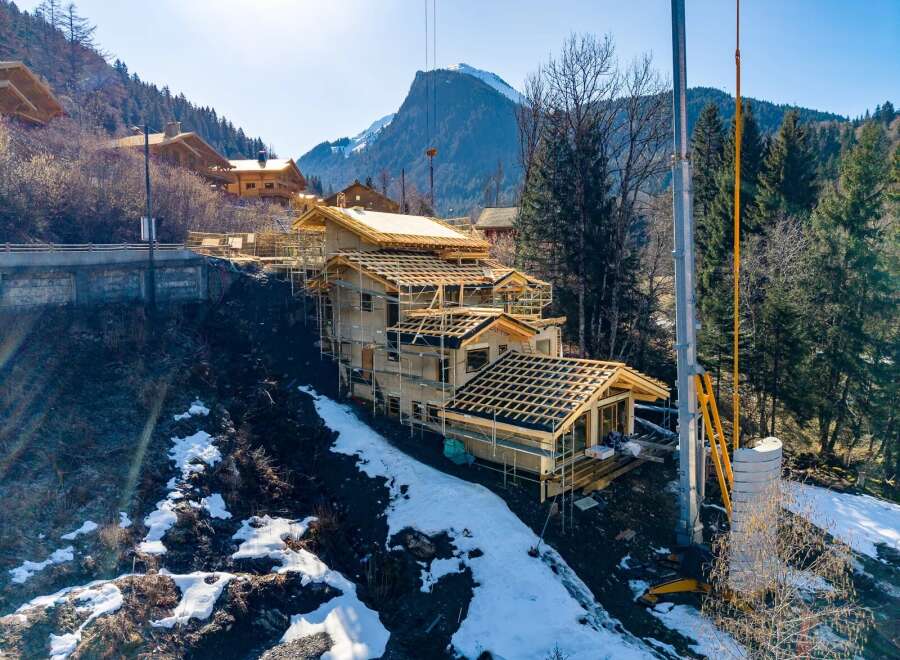 Discover a stunning mountain home under construction, showcasing exceptional craftsmanship and design.