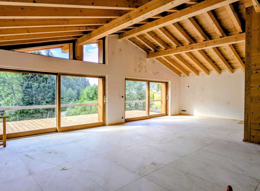 Experience modern living with stunning natural views in this unfinished interior space.