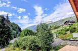 Experience breathtaking mountain views from this stunning property, nestled amidst lush greenery and towering trees.