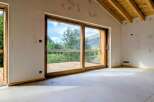 Experience breathtaking mountain views from this stunning property, featuring expansive sliding glass doors that open onto a private wooden deck.