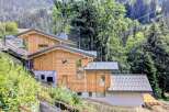 Discover this stunning modern chalet nestled in a serene mountain landscape, perfect for those seeking a blend of contemporary design and natural beauty.