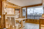This charming property boasts a rustic interior with exposed wooden beams and a cozy dining area.
