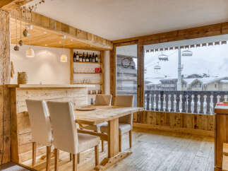 This charming property boasts a rustic interior with exposed wooden beams and a cozy dining area.