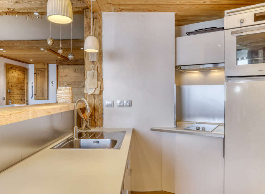 This charming kitchen boasts a rustic design with wooden beams and a modern touch.