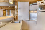 This charming kitchen boasts a rustic design with wooden beams and a modern touch.