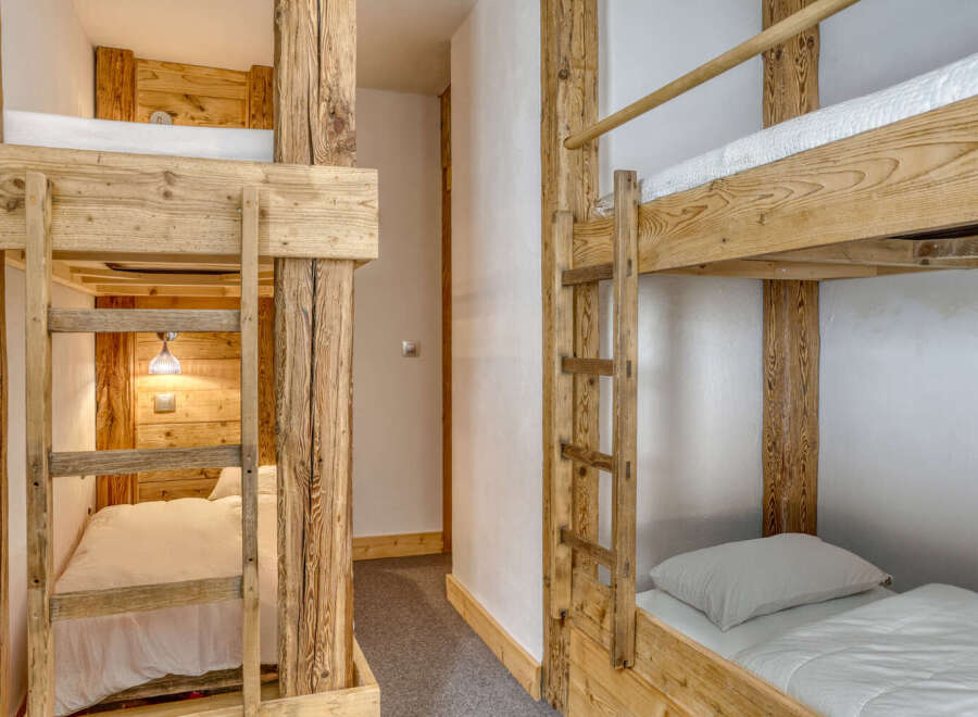 Discover the charm of this cozy bunk room, perfect for a family getaway or a group of friends.