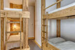 Discover the charm of this cozy bunk room, perfect for a family getaway or a group of friends.