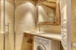 This rustic bathroom features a unique wooden-framed mirror and a stylish sink area.