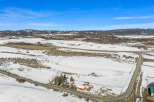 Discover a picturesque rural property nestled in a serene winter landscape.