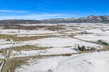 Discover the serene beauty of this expansive property, nestled in a picturesque winter landscape.