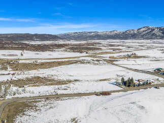 Discover the serene beauty of this expansive property, nestled in a picturesque winter landscape.
