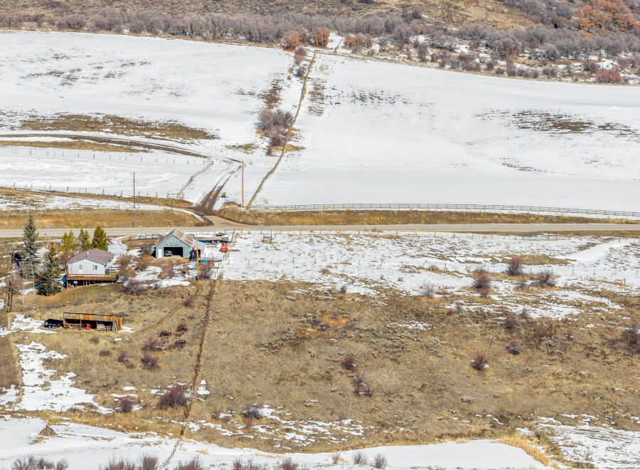 Nestled in a serene winter landscape, this property offers a unique blend of natural beauty and rustic charm.