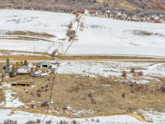 Nestled in a serene winter landscape, this property offers a unique blend of natural beauty and rustic charm.