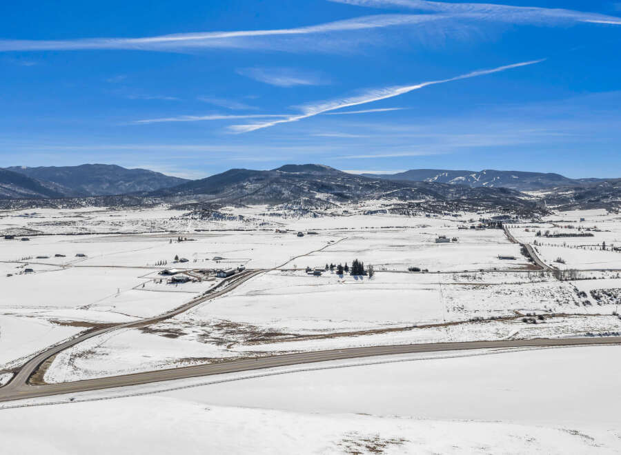 This stunning aerial view showcases a picturesque winter landscape, perfect for those seeking a serene retreat.