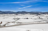 This stunning aerial view showcases a picturesque winter landscape, perfect for those seeking a serene retreat.