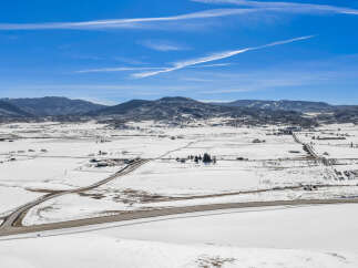 This stunning aerial view showcases a picturesque winter landscape, perfect for those seeking a serene retreat.