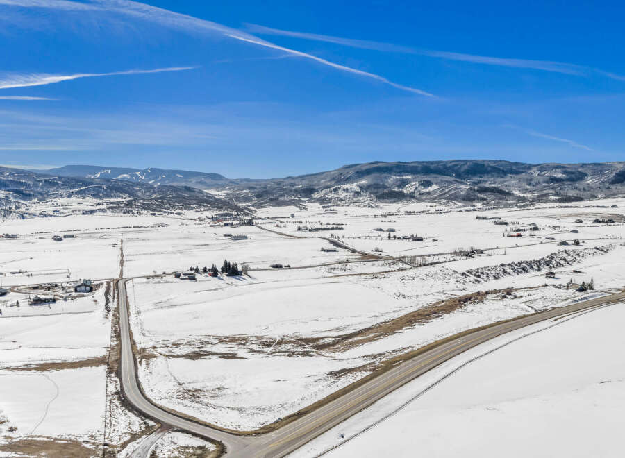 This stunning aerial view showcases a picturesque winter landscape, perfect for those seeking a serene retreat.