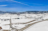 This stunning aerial view showcases a picturesque winter landscape, perfect for those seeking a serene retreat.