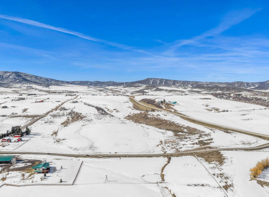 This stunning aerial view showcases a picturesque winter landscape, perfect for those seeking a serene escape.
