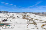 This stunning aerial view showcases a picturesque winter landscape, perfect for those seeking a serene escape.