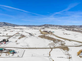This stunning aerial view showcases a picturesque winter landscape, perfect for those seeking a serene escape.