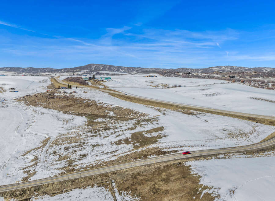 This stunning property offers breathtaking views of the snow-covered landscape and rolling hills.