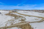 This stunning property offers breathtaking views of the snow-covered landscape and rolling hills.