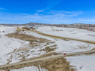 This stunning property offers breathtaking views of the snow-covered landscape and rolling hills.