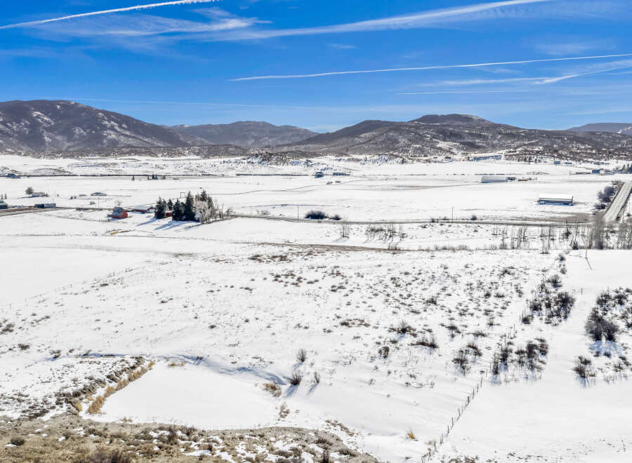 This stunning property offers a serene winter landscape, perfect for those seeking tranquility.