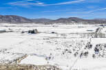 This stunning property offers a serene winter landscape, perfect for those seeking tranquility.