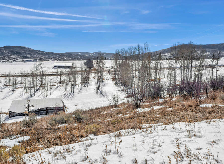 This stunning property offers a serene escape with breathtaking views of snow-covered landscapes and rolling hills.