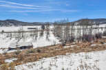 This stunning property offers a serene escape with breathtaking views of snow-covered landscapes and rolling hills.