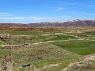 Discover this expansive rural property offering breathtaking mountain views and vast open fields.