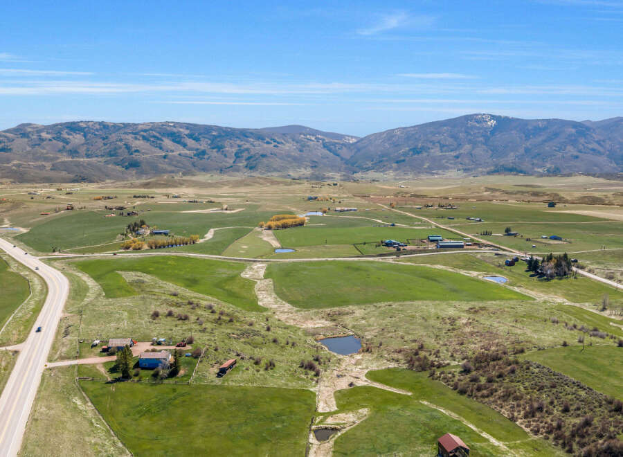 Discover this expansive rural property, featuring rolling green pastures and scenic mountain views.