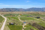 Discover this expansive rural property, featuring rolling green pastures and scenic mountain views.