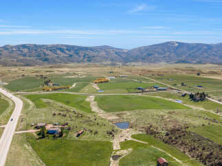 Discover this expansive rural property, featuring rolling green pastures and scenic mountain views.