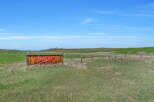 Discover this unique property featuring a rustic wooden sign with bold red lettering that reads 'JASPIP'.