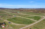 Discover this expansive rural property featuring rolling green hills, picturesque ponds, and a charming farmstead.