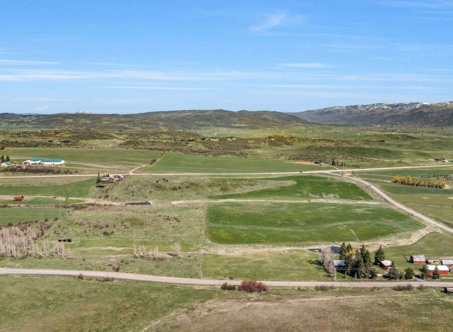 Discover this expansive rural property offering breathtaking panoramic views of rolling hills and distant snow-capped mountains.