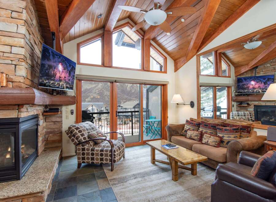 Experience luxury living in this stunning property featuring a cozy fireplace and a modern TV setup.