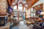 Experience luxury living in this stunning property featuring a cozy fireplace and a modern TV setup.
