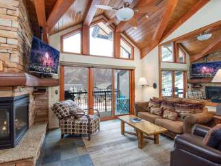 Experience luxury living in this stunning property featuring a cozy fireplace and a modern TV setup.