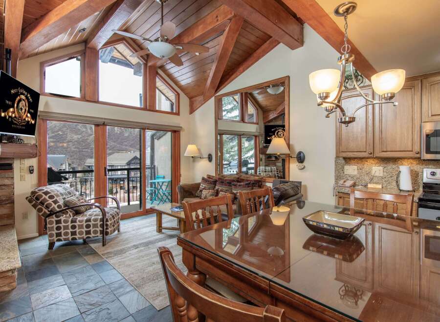 Experience luxury living in this stunning property, featuring a spacious living area with a cozy fireplace and a modern kitchen.