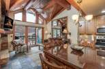 Experience luxury living in this stunning property, featuring a spacious living area with a cozy fireplace and a modern kitchen.