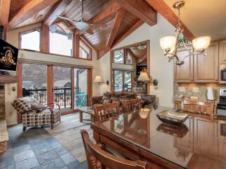 Experience luxury living in this stunning property, featuring a spacious living area with a cozy fireplace and a modern kitchen.