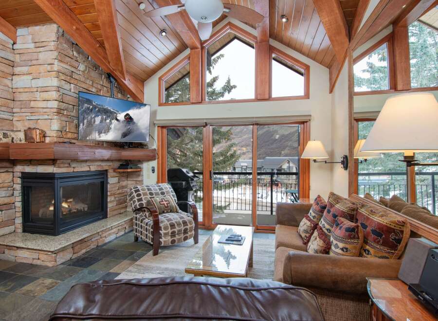 Experience luxury living in this stunning property featuring a cozy fireplace and a modern TV setup.
