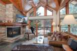 Experience luxury living in this stunning property featuring a cozy fireplace and a modern TV setup.