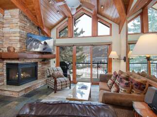 Experience luxury living in this stunning property featuring a cozy fireplace and a modern TV setup.