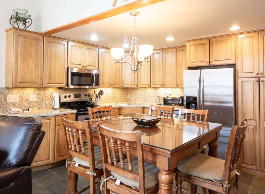 This stunning kitchen features beautiful wooden cabinetry, offering ample storage and a warm, inviting atmosphere.